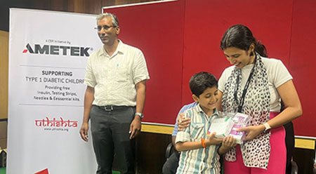 AMETEK India team members hand out diabetic care kits to children