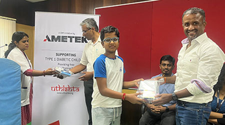 AMETEK India team members hand out diabetic care kits to children